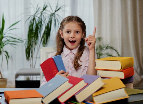 Positive little girl likes reading.