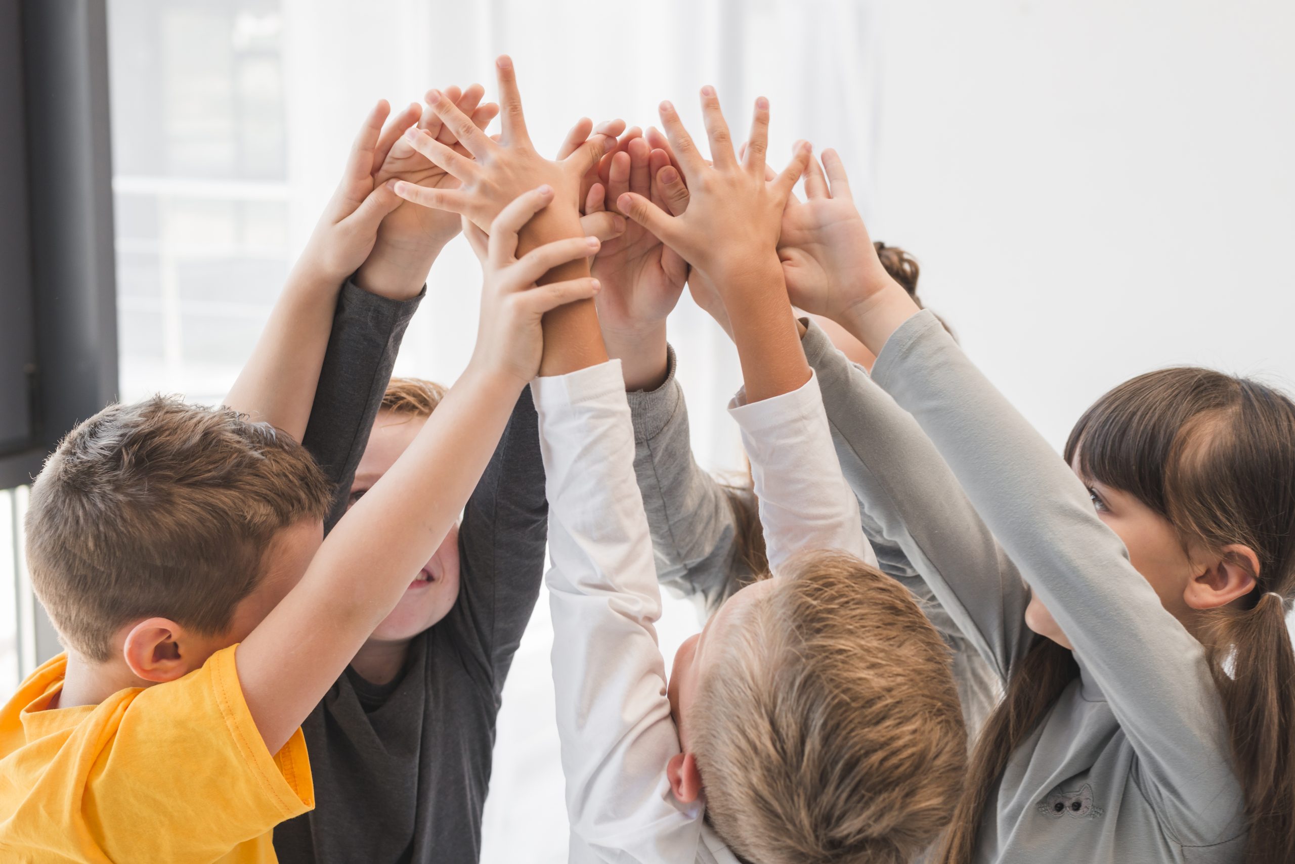 children-with-their-hands-up