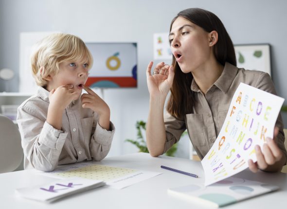 woman-doing-speech-therapy-with-little-blonde-boy